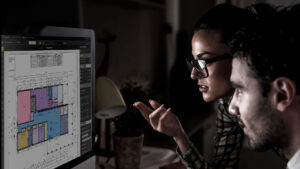 a man and woman looking at a computer sfe rite estimating screen