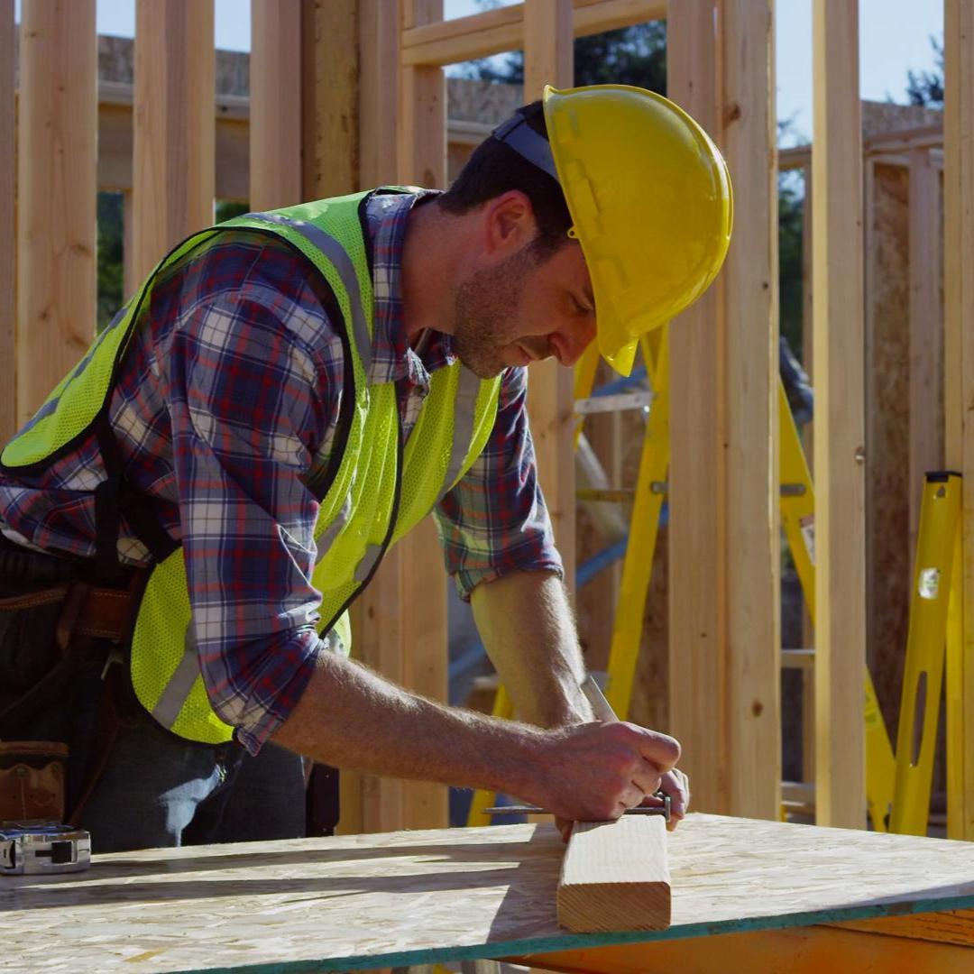 Carpenter measuring pice of timber 